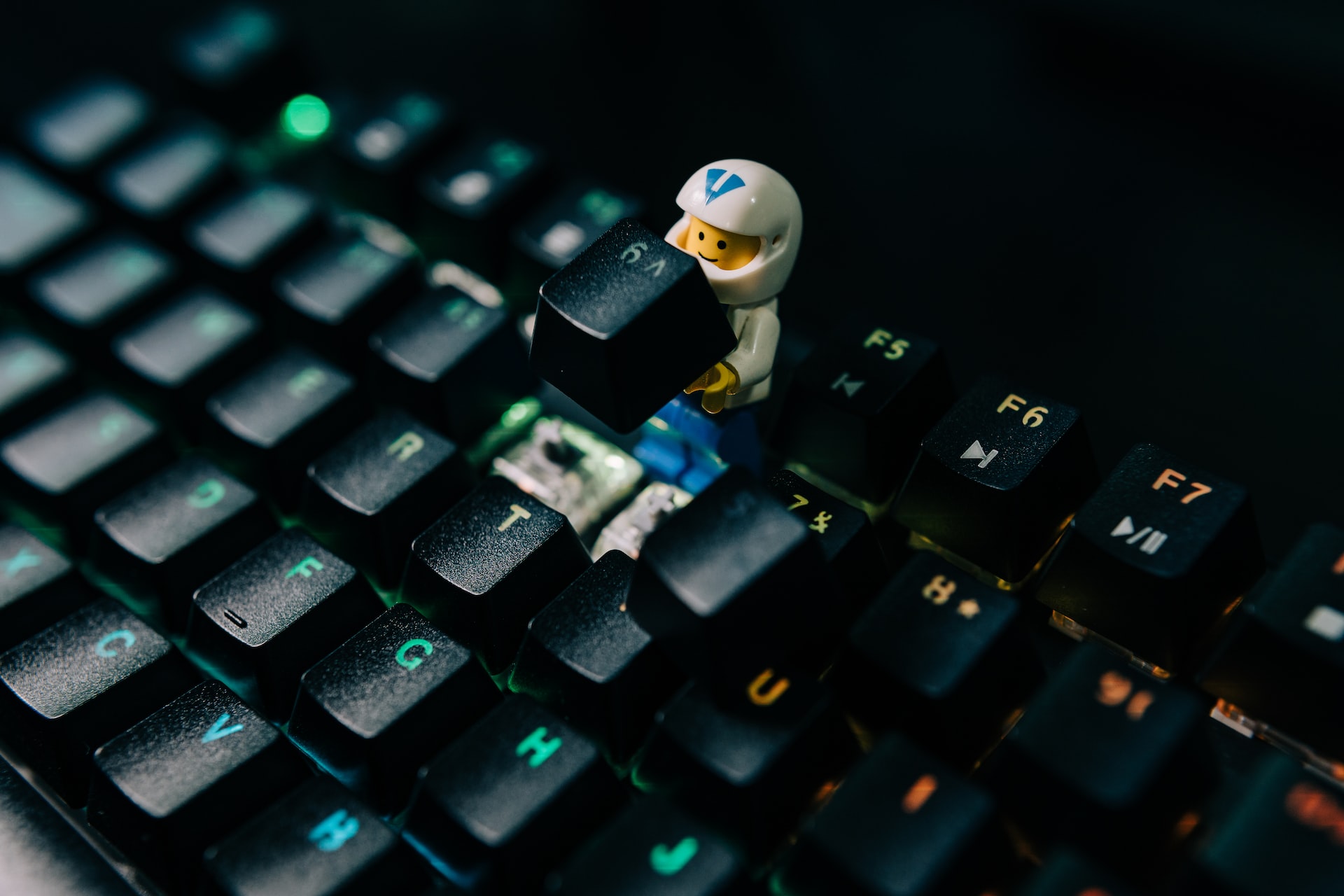 A small lego astronaut replacing the ^ key.
